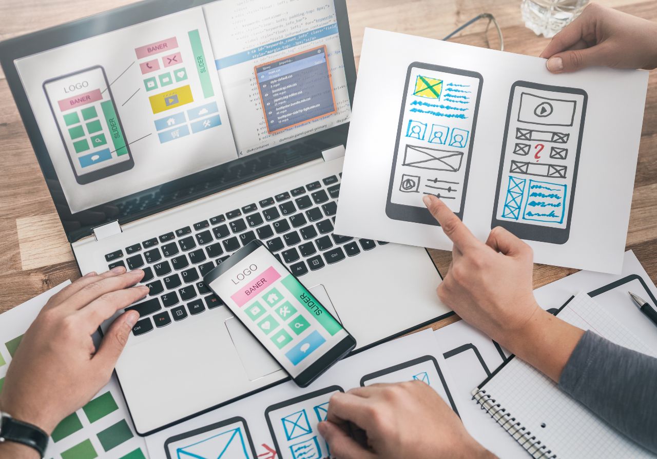 Laptop screens displaying website analytics and design dashboards on a desk